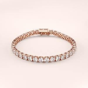 Elegant diamond tennis bracelet featuring round brilliant cut diamonds in a secure four-prong setting. Available in 14K or 18K white, yellow, or rose gold. Timeless luxury and radiant sparkle for any occasion. 
