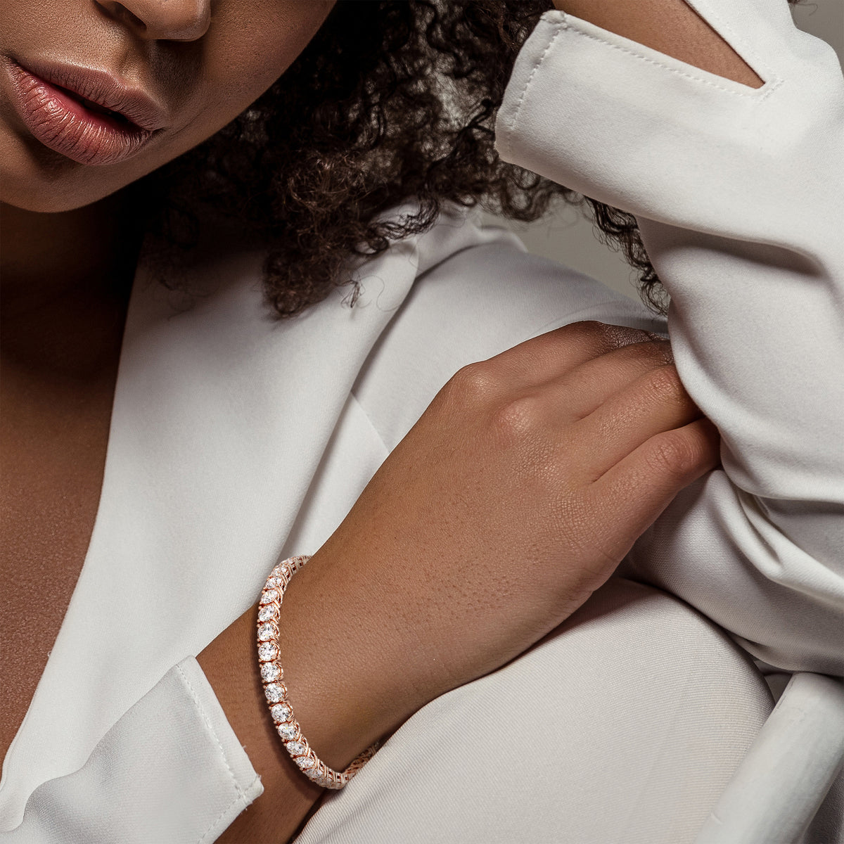 Diamond tennis bracelet on model featuring round brilliant cut diamonds in a secure four-prong setting. Available in 14K or 18K white, yellow, or rose gold. Timeless luxury and radiant sparkle for any occasion. 