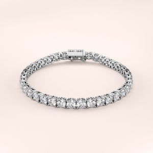 Elegant diamond tennis bracelet featuring round brilliant cut diamonds in a secure four-prong setting. Available in 14K or 18K white, yellow, or rose gold. Timeless luxury and radiant sparkle for any occasion. 