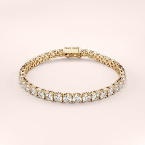 Elegant diamond tennis bracelet featuring round brilliant cut diamonds in a secure four-prong setting. Available in 14K or 18K white, yellow, or rose gold. Timeless luxury and radiant sparkle for any occasion. 