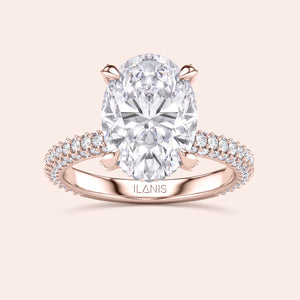 Oval cut diamond engagement ring in rose gold with pavé band and hidden halo, classic solitaire design with sparkling diamond accents 