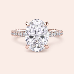 Oval diamond ring in rose gold, top view highlighting brilliance of center stone and micro pavé diamonds along the band 