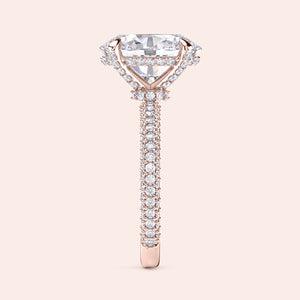 Oval diamond engagement ring in rose gold with hidden halo and pavé band, side angle showing intricate prong setting and diamond gallery 