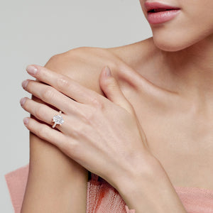 Oval cut diamond ring in rose gold on hand, lifestyle image highlighting sparkle, pavé band and refined feminine design 