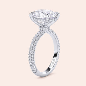 Pear diamond engagement ring in white gold with three stone setting, side angle showing prong setting and clean architectural lines 