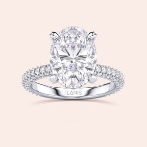Pear shaped diamond ring in white gold, top view highlighting brilliance of center stone and symmetry of baguette side diamonds 