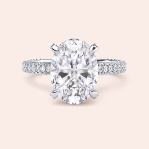 Pear cut diamond engagement ring in white gold with tapered baguette side stones, classic three stone design with brilliant center diamond 