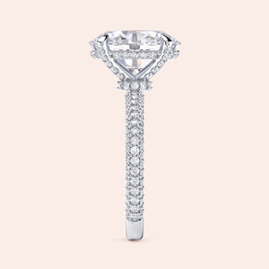 Pear shaped diamond engagement ring in white gold with three stone setting and tapered baguette side diamonds, side profile showcasing elevated setting and fine craftsmanship 
