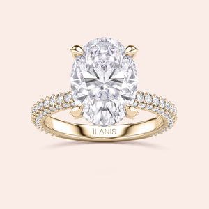 Pear shaped diamond ring in yellow gold, top view highlighting brilliance of center stone and symmetry of baguette side diamonds 