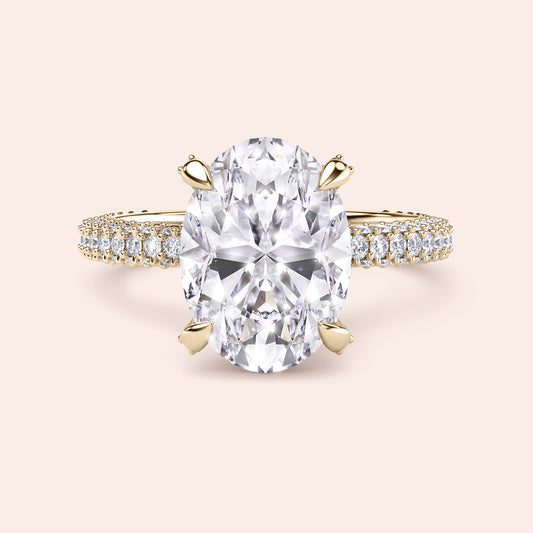 Pear cut diamond engagement ring in yellow gold with tapered baguette side stones, classic three stone design with brilliant center diamond 