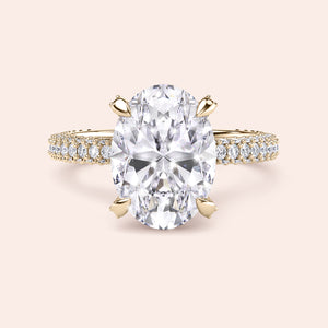 Pear cut diamond engagement ring in yellow gold with tapered baguette side stones, classic three stone design with brilliant center diamond 