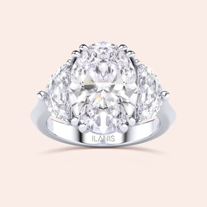 Oval shaped diamond ring in white gold, top view highlighting brilliance of center diamond and symmetry of pear side stones 