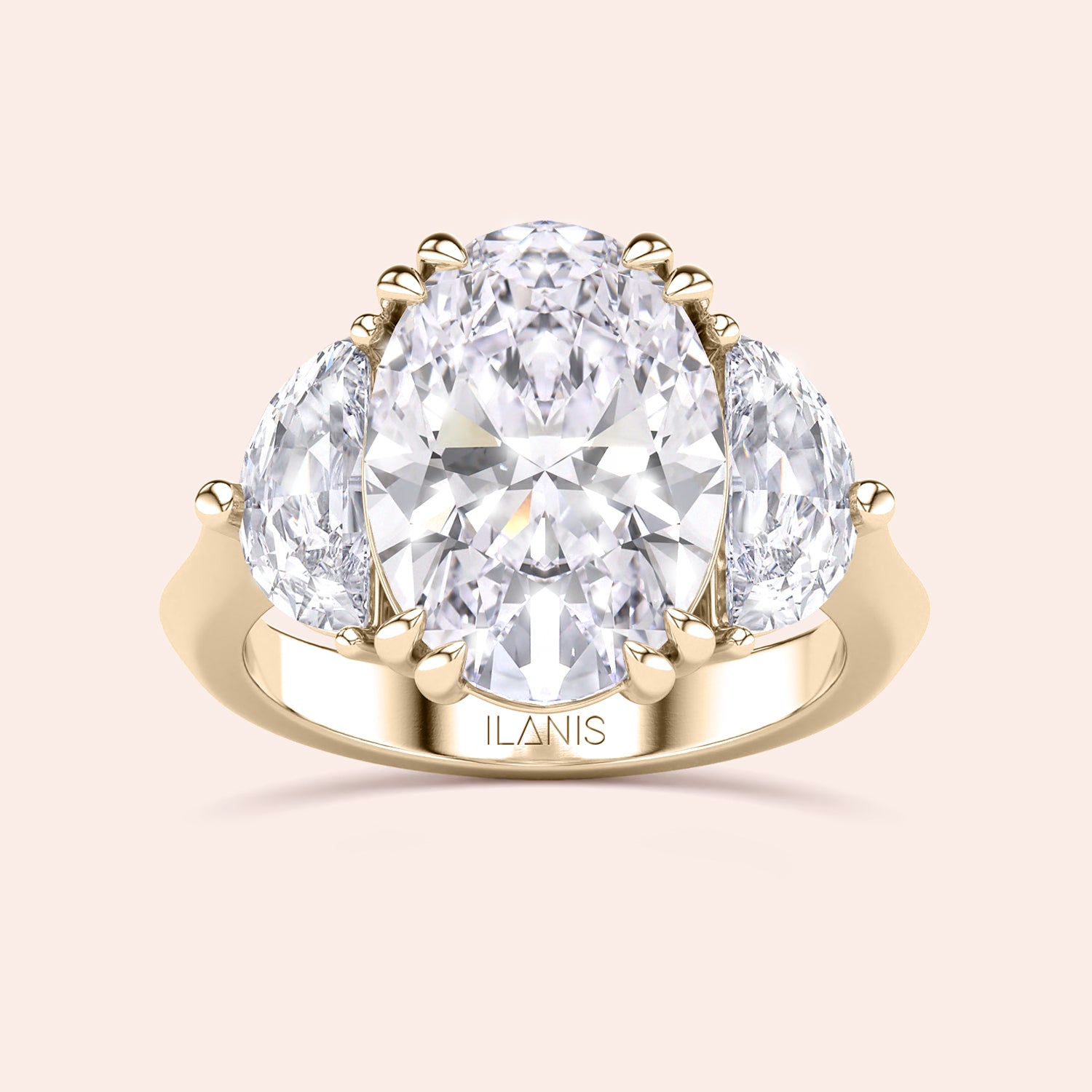 Oval shaped diamond ring in yellow gold, top view highlighting brilliance of center diamond and symmetry of pear side stones | #14KRecycledYellowGold #18KRecycledYellowGold