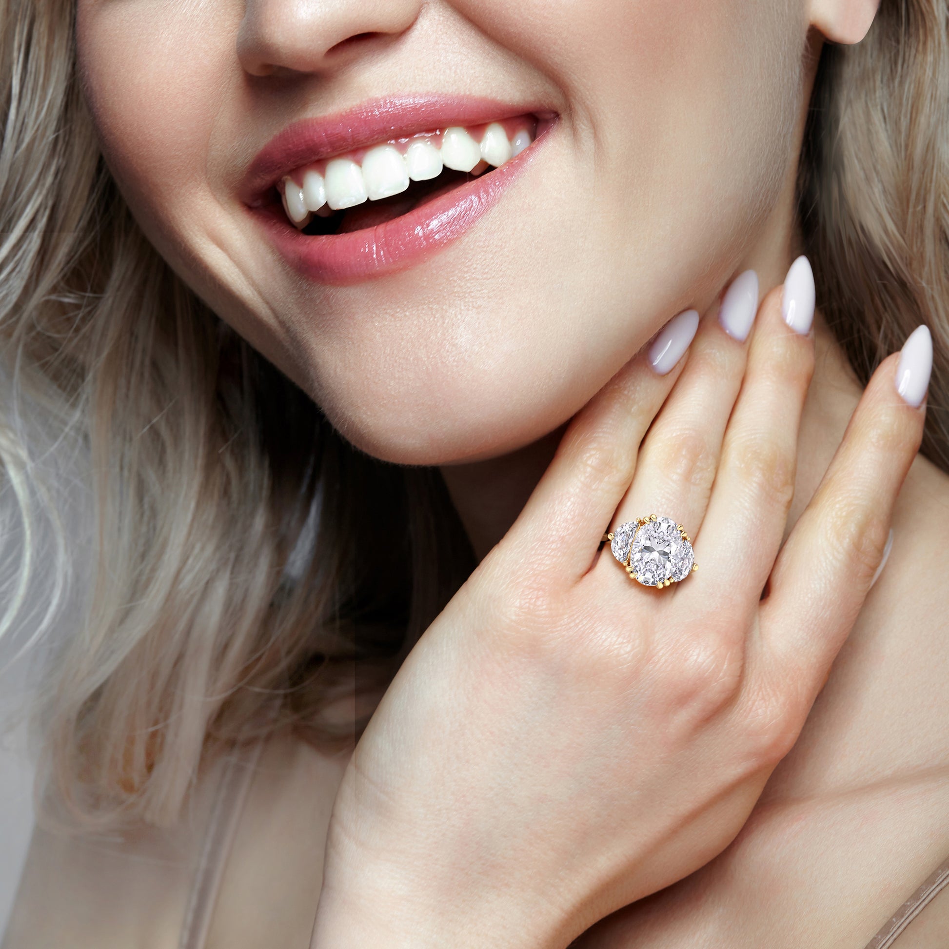 Oval cut diamond ring in yellow gold on hand, lifestyle image highlighting brilliance, proportions and rich golden glow | #14KRecycledYellowGold #18KRecycledYellowGold