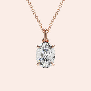 A close-up of a stunning oval-cut diamond pendant in a four-prong rose gold setting. The minimalist yet elegant design highlights the brilliance of the diamond, making it perfect for any occasion.
