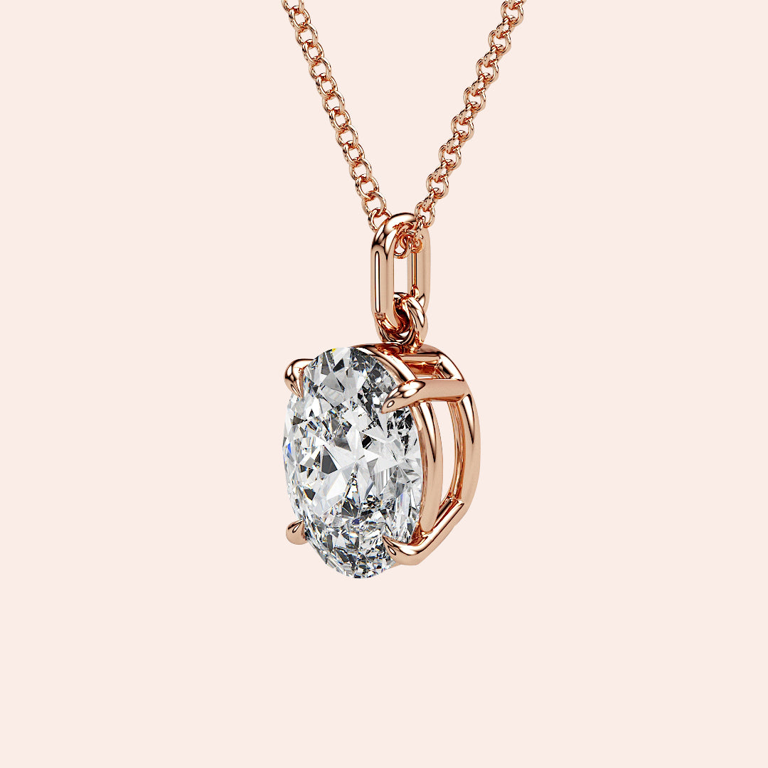 A refined side profile of an oval-cut diamond solitaire pendant in rose gold, featuring an open-prong setting for maximum light reflection and sparkle. A modern classic with a soft, feminine touch.
