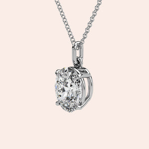 A detailed side view of an oval-cut solitaire diamond pendant in white gold, featuring a secure prong setting that maximizes light reflection for extraordinary brilliance.
