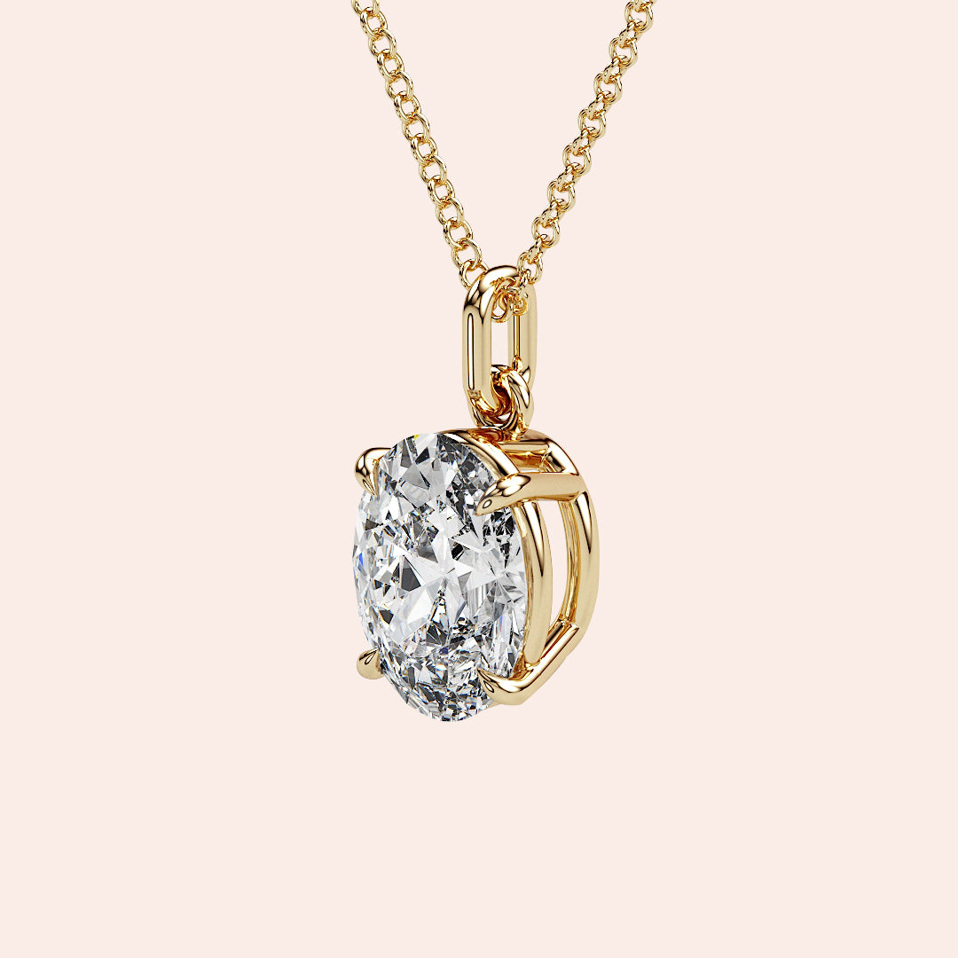 A detailed side view of an oval-cut solitaire diamond pendant in yellow gold, designed with a secure prong setting that allows maximum light reflection for unparalleled brilliance.
