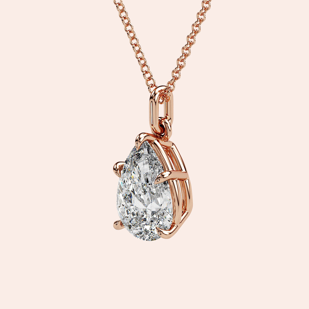 A detailed side profile of a pear-shaped diamond pendant in rose gold, showcasing its stunning craftsmanship and delicate basket setting that allows for optimal light reflection.

