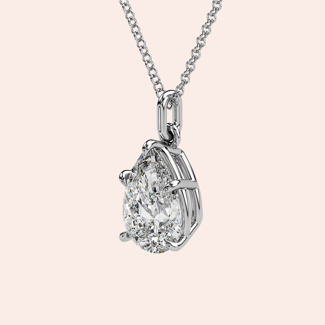 A detailed side profile of a pear-shaped diamond pendant in white gold, showcasing its stunning craftsmanship and delicate basket setting that allows for optimal light reflection.
