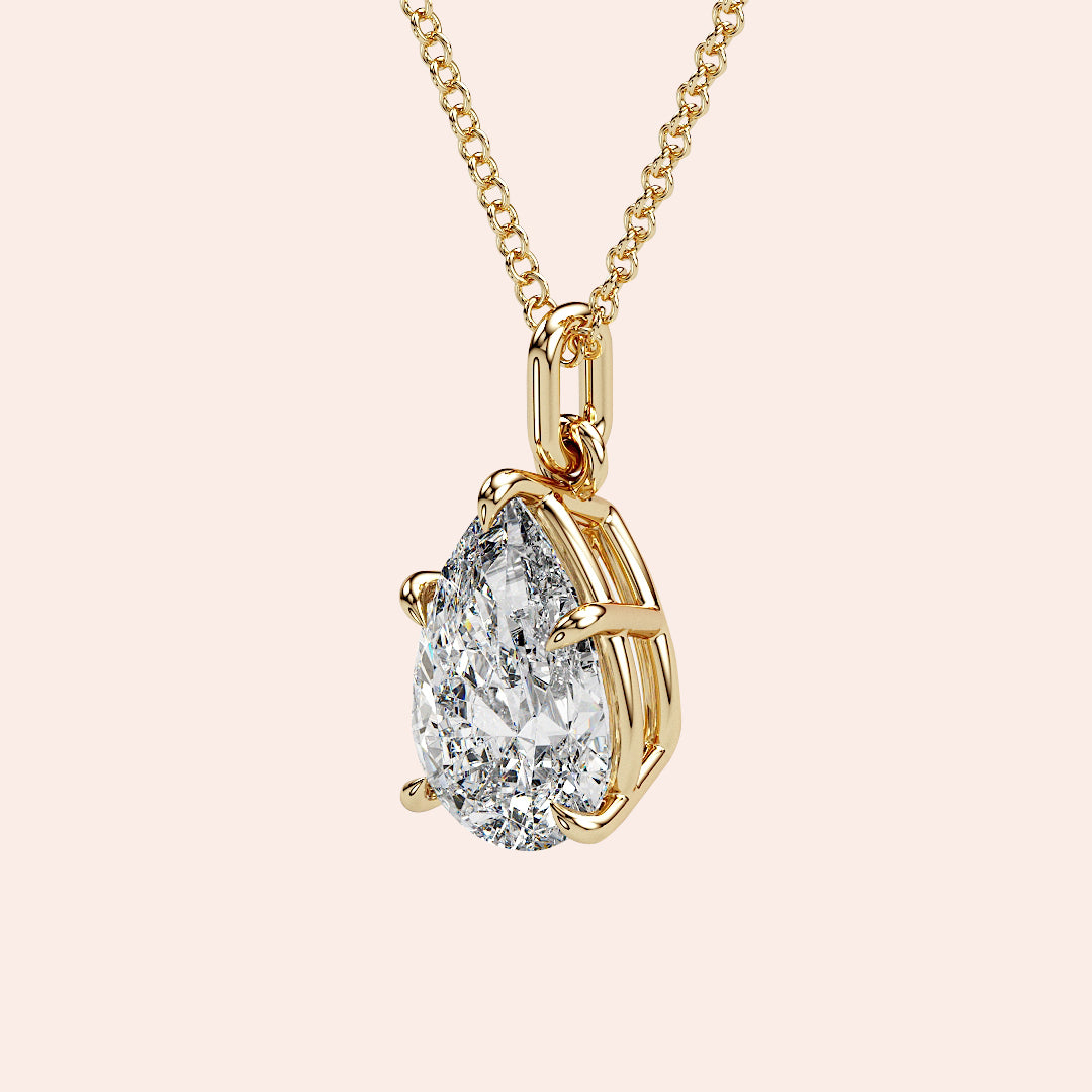 A refined side profile of a pear-shaped diamond pendant in yellow gold, featuring an airy, open-prong setting that maximizes brilliance and light return. A perfect balance of modern elegance and classic appeal.
