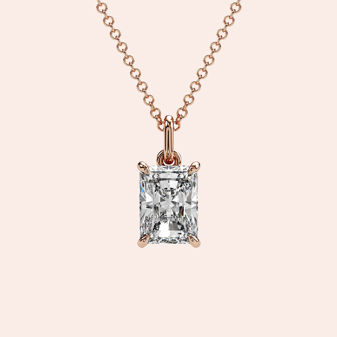 A timeless radiant-cut solitaire diamond pendant set in a four-prong rose gold setting. The clean lines of the radiant cut enhance the brilliance, making it an elegant and modern choice.
| #14KRecycledRoseGold #18KRecycledRoseGold