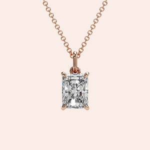 A timeless radiant-cut solitaire diamond pendant set in a four-prong rose gold setting. The clean lines of the radiant cut enhance the brilliance, making it an elegant and modern choice.
