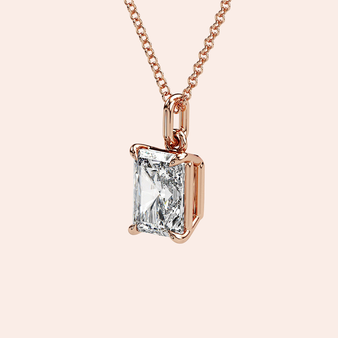 A side-angle close-up of the radiant-cut solitaire diamond pendant in a warm rose gold setting. The sturdy yet delicate prongs securely hold the diamond, allowing maximum light reflection.
| #14KRecycledRoseGold #18KRecycledRoseGold