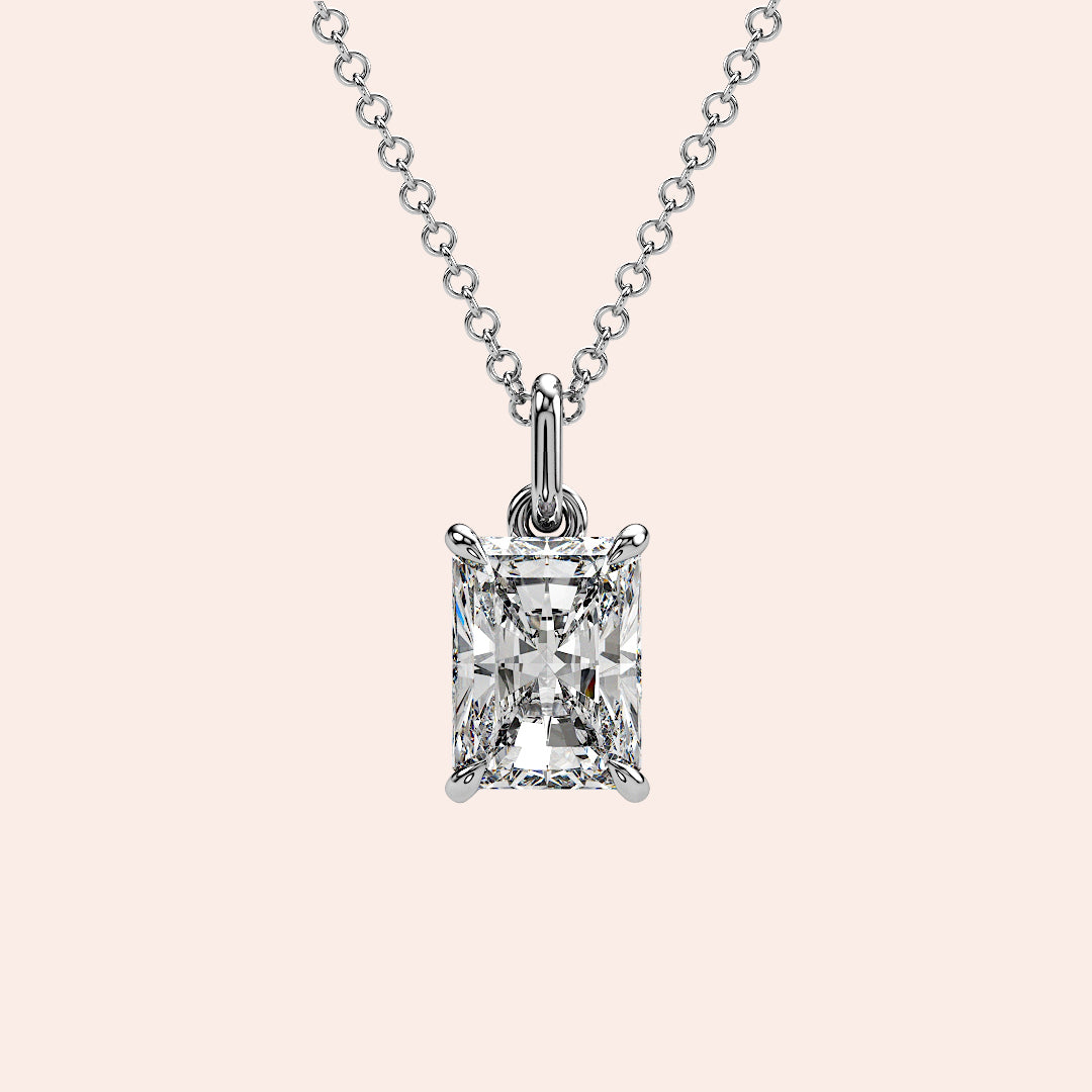 A close-up of a solitaire radiant-cut diamond pendant in a classic four-prong white gold setting. The clean lines and exquisite craftsmanship highlight the stone’s unique facets.
| #14KRecycledWhiteGold #18KRecycledWhiteGold