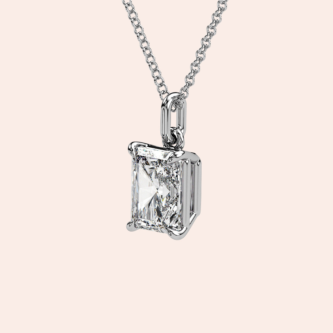 A detailed side view of a radiant-cut diamond solitaire pendant in a refined white gold basket setting. The secure design allows maximum light reflection for a breathtaking shimmer.
| #14KRecycledWhiteGold #18KRecycledWhiteGold