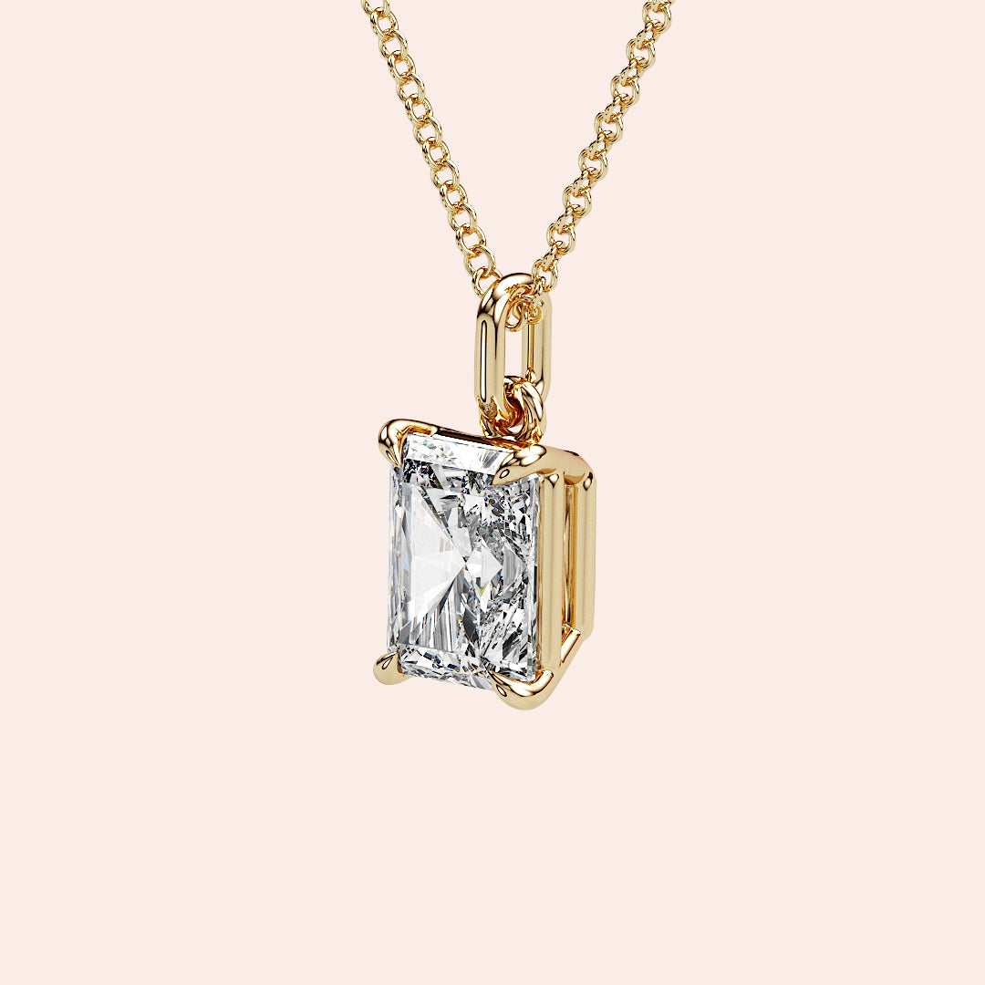 A detailed side view of a radiant-cut diamond solitaire pendant in a four-prong yellow gold basket setting. The intricate craftsmanship ensures the perfect balance of security and elegance.
| #14KRecycledYellowGold #18KRecycledYellowGold