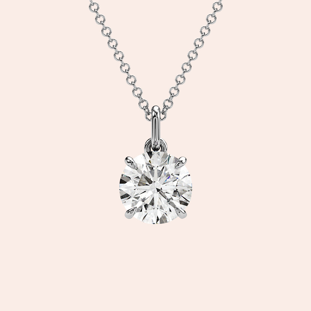 A close-up of a solitaire round-cut diamond pendant in a classic four-prong white gold setting. The pendant’s design ensures maximum brilliance and elegance.
