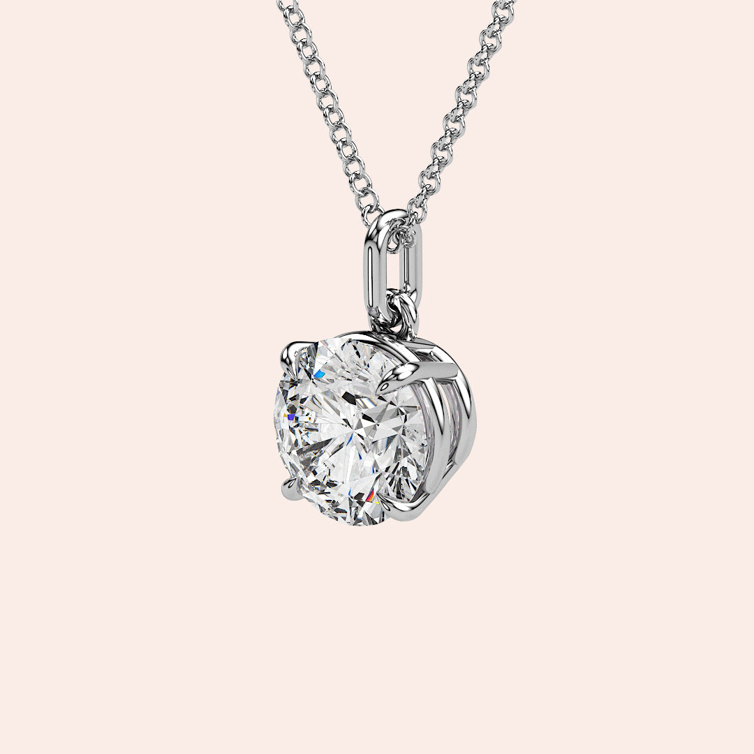 A detailed side view of a round-cut diamond solitaire pendant in white gold, showcasing its secure yet delicate prong setting. A timeless piece designed for those who appreciate refined beauty.
| #14KRecycledWhiteGold #18KRecycledWhiteGold
