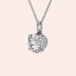 A detailed side view of a round-cut diamond solitaire pendant in white gold, showcasing its secure yet delicate prong setting. A timeless piece designed for those who appreciate refined beauty.
