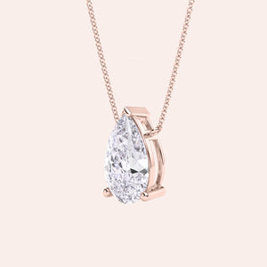 Pear shaped diamond pendant necklace in rose gold, side view of solitaire setting, minimal and refined fine jewelry 