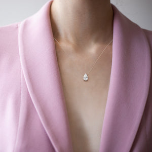 Pear diamond solitaire necklace in rose gold, fine jewelry pendant styled on model, timeless and feminine everyday piece 