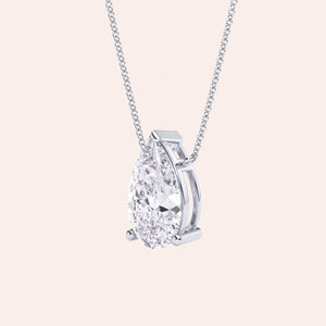 Pear shaped diamond pendant necklace in white gold, side view of solitaire setting, minimal and refined fine jewelry 