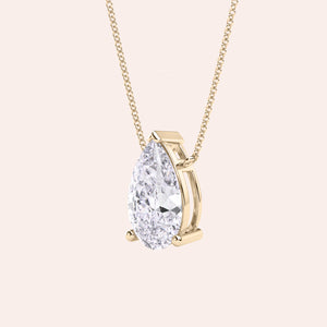 Pear shaped diamond pendant necklace in yellow gold, side view of solitaire setting, minimal and refined fine jewelry 