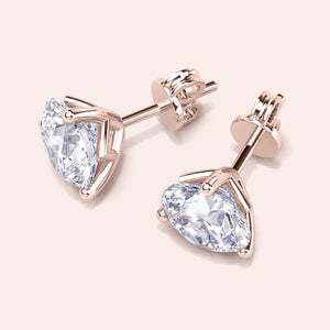 Timeless 3-Prong Martini Diamond Stud Earrings in 14kt/18kt rose gold on a soft pink background 