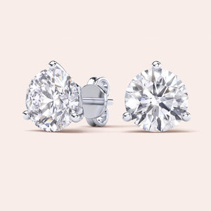 Timeless 3-Prong Martini Diamond Stud Earrings in white gold on a soft pink background 