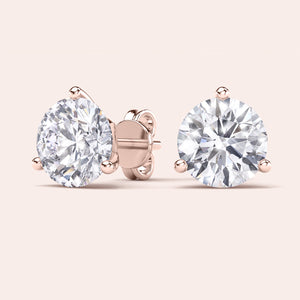Timeless 3-Prong Martini Diamond Stud Earrings in 14kt/18kt rose gold on a soft pink background 