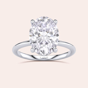 Elegant oval-cut diamond solitaire ring in 14K or 18K gold or platinum, featuring a stunning centerpiece on a sleek band.