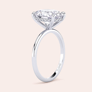 Elegant round diamond engagement ring in 14K or 18K white gold or platinum, featuring a classic solitaire and sparkling diamond cluster.
