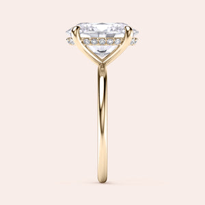Gold solitaire engagement ring in 14K or 18K gold or platinum, featuring an emerald-cut diamond and smaller accent diamonds.
