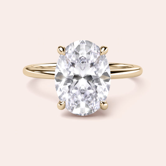 Elegant oval diamond engagement ring in polished 14K gold, luxurious 18K gold, or premium platinum, showcasing a stunning solitaire design.