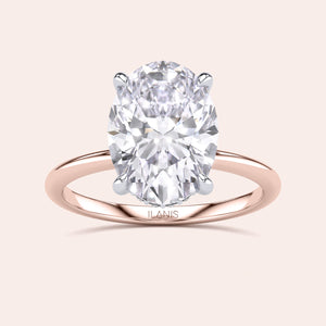Two-tone 14K/18K white and rose gold engagement ring featuring an oval-cut diamond centerpiece in a Secret Halo design. 