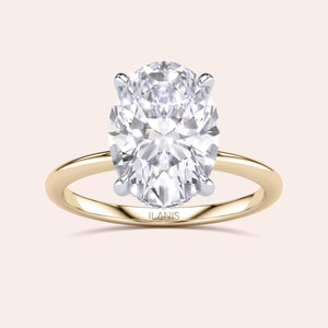 Two-tone 14K/18K gold engagement ring featuring an oval-cut diamond in white and yellow gold design. 
