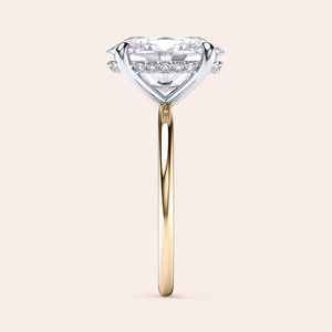 Two-tone 14K/18K gold engagement ring featuring an oval-cut diamond in a secret halo setting, blending white and yellow gold. 