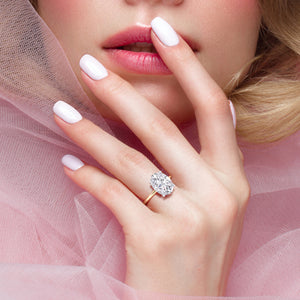 Oval-cut two-tone diamond ring in 14K white and yellow gold, showcased on a model?s hand for elegance and style. 