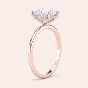 Detail of a stunning solitaire ring with a round-cut diamond, set in 14K or 18K gold or platinum with pave accents. 